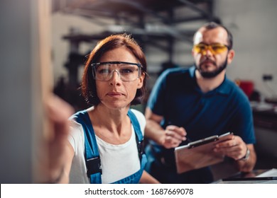 Female Worker Operate Machine In Factory