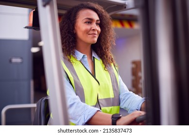 Female Worker Operating Fork Lift Truck At Freight Haulage Business