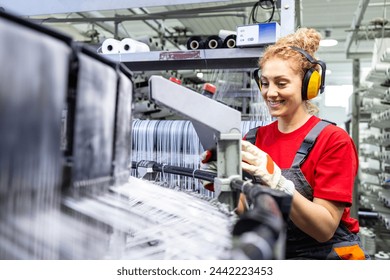 Female worker operating sewing machine for plastic bags production. - Powered by Shutterstock