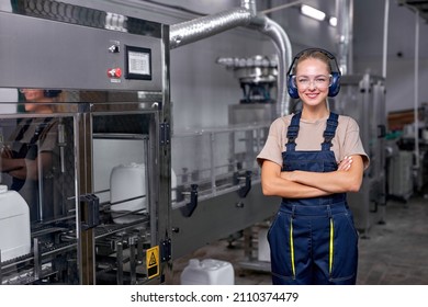 Female worker in protective uniform working in medical supplies research and pesticides production factory, woman is controlling production of bottles canisters before shipment. Industrial warehouse. - Powered by Shutterstock