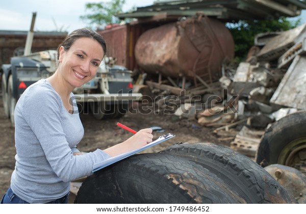 female working at junk\
yard