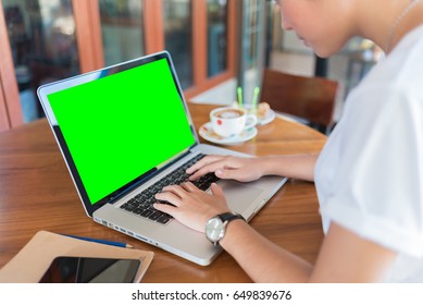 Female working on laptop in a cafe.  - Powered by Shutterstock