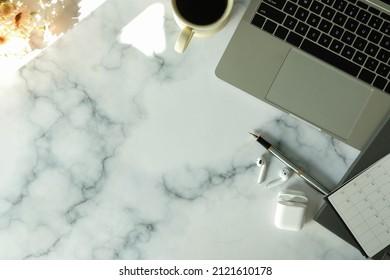 Female Workplace With Laptop Computer, Coffee Cup, Notebook And Wireless Ear Phones On Marble Background.