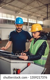 Female Workplace Safety Inspector Preforming Inspection At Industrial Factory