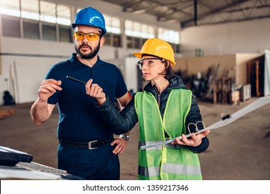 Female Workplace Safety Inspector Writing A Report At Industrial Factory