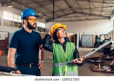 Female Workplace Safety Inspector Writing A Report At Industrial Factory