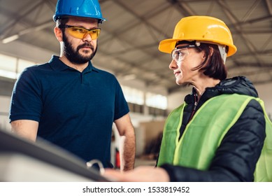 Female Workplace Safety Inspector Writing A Report At Industrial Factory