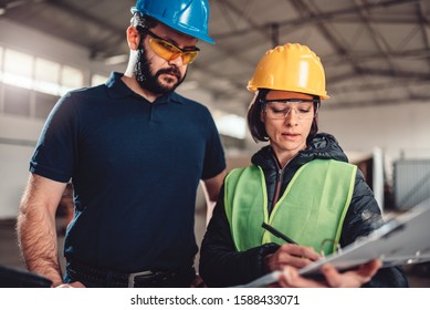 Female Workplace Safety Inspector Writing A Report At Industrial Factory