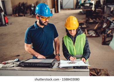 Female Workplace Safety Inspector Writing A Report At Industrial Factory