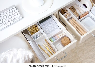 Female Workplace. White Work Table. The Stylish Gold Stationery Is Arranged Very Neatly In The Drawers Of The Desk. Japanese Storage Method.