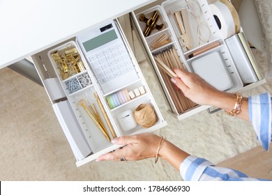 Female workplace. White work table. The stylish gold stationery is arranged very neatly in the drawers of the desk. Japanese storage method. - Shutterstock ID 1784606930