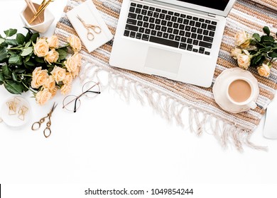 Female workspace with laptop, roses flowers bouquet, golden accessories, diary, computer, glasses on white background. Flat lay women's office desk. Top view feminine background.