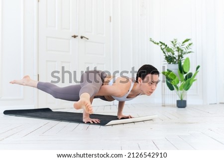 Female yoga teacher practicing in studio. Woman doing a handstand