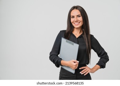 Female young businesswoman auditor inspector examiner controller in formal wear writing on clipboard, checking the quality of goods and service looking at camera isolated in white background - Shutterstock ID 2139568135