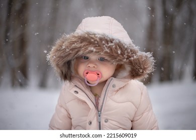 Female Young Child Outdoors With Pacifier In Winter Wearing A Pi