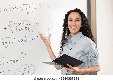 Female young Hispanic university teacher, college tutor explaining math giving remote school class online lesson teaching looking at camera in classroom by elearning video conference zoom call. - Powered by Shutterstock