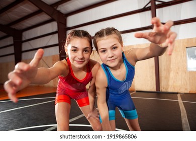 Female Youth Wrestling Teammates In Blue And Red Singlets