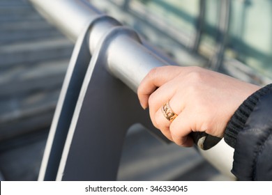 Female's hand holding handrail