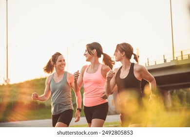 The females in sportswear walking together bright sunny park in summer - Powered by Shutterstock