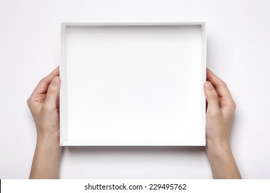 A Female(woman, Girl) Two Hands Hold The Empty(blank) White Box Isolated White, Top View At The Studio.