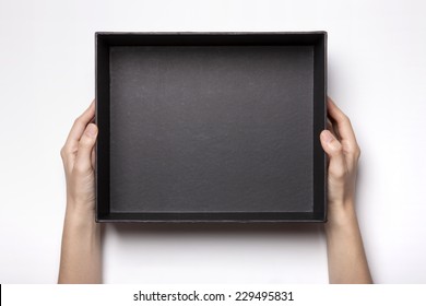 A Female(woman, Girl) Two Hands Hold And Open The Empty(blank) Black Box Isolated White, Top View At The Studio.