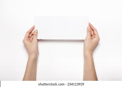 A female(woman) hand hold the empty envelope isolated white, top view at the studio.