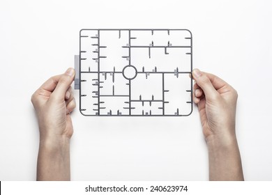 A Female(woman) Hand Hold A Trash(part, Set, Kit) Of Plastic Model(toy) Isolated White, Top View At The Studio.