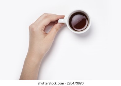 Female(woman) Hand Hold A White Espresso Cup With Coffee Isolated White And Top View.