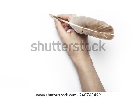 A female(woman) hand hold(write) a feather quill pen on the letter and envelope.