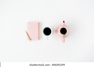 Feminine trendy home space: pink diary, teapot, coffee mug and golden pen. Flat lay, top view