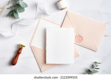 Feminine Wedding Invitation. Blank Paper Card Mockup, Pink Envelopes, Silk Ribbon, Eucalyptus, Wax Seal Stamp On Marble Table. Wedding Stationery Template.