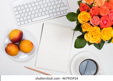Feminine white desk workspace with flowers, startup concept