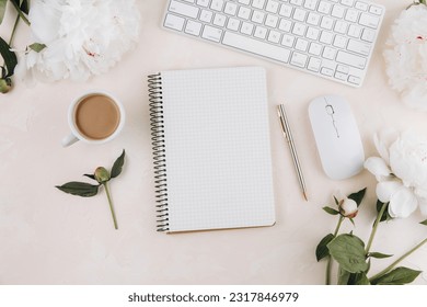 Feminine workspace with blank open notepad and cup of coffee milk, keyboard, stylish office writing supplies and on a pastel teble - Powered by Shutterstock