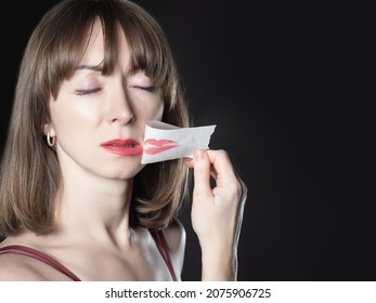 Feminism Protest Concept. Scotch Tape As A Symbol Of Restriction Of Women Rights. Removing Tape From Mouth Symbolizes The Feminism Protest. Feminist  Woman Face On Black Background.