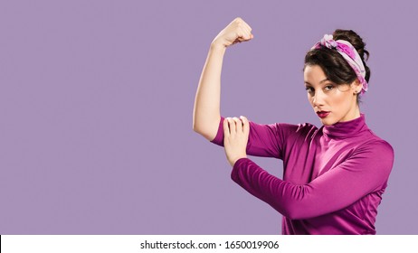 Feminist woman showing her power and copy space background 