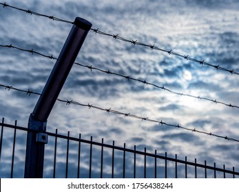 a fence with barbed wire - Shutterstock ID 1756438244