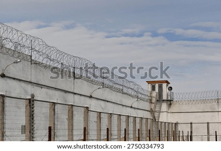 A fence with barbed wire inside the prison