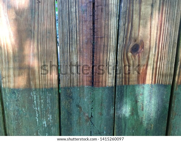 Fence before and after\
pressure wash.