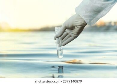 Fence, check the water sample for infections. Gloved hand with flask and a test tube on a background of lake, river, sea. Pollution of ecology, environment