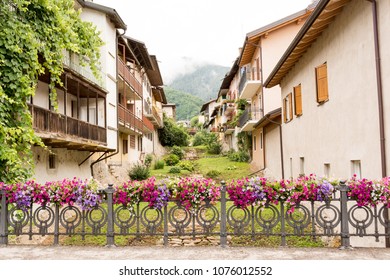 fence decorated with flower vases in the Levico Terme , a village in the Italian Alps
