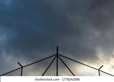 A fence with a dramatic sky in the background - Shutterstock ID 1778242088