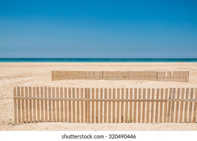 Fence On A White Sand Beach In Tarifa, Andalusia