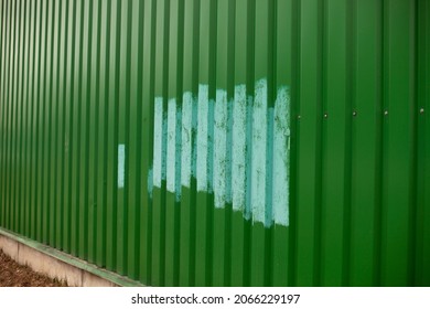 Fence Painted After Vandalism. Painting Over Graffiti On The Fence. Blue Paint On A Green Steel Fence.