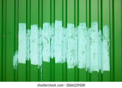 Fence Painted After Vandalism. Painting Over Graffiti On The Fence. Blue Paint On A Green Steel Fence.