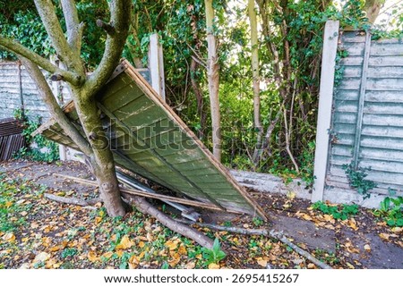 Fence panel damage after a storm, high winds and bad weather cause demolition to garden fencing