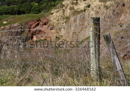 Fence  post and barbed wire. Halswell Quarry, Christchurch, New Zealand