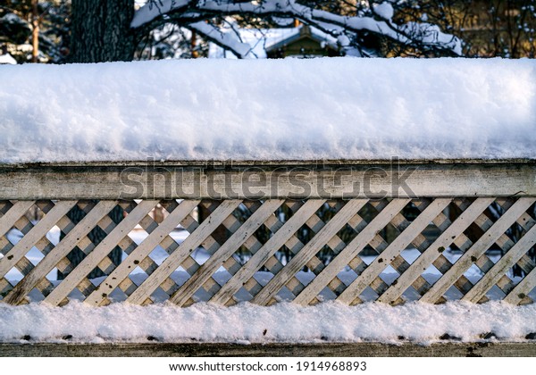 The fence posts\
are covered with white snow