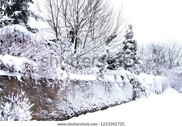 fence and a street in the\
snow