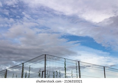 fence in a water catchment against a blue sky background