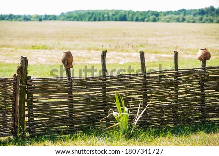 Fence wicker from the vine, texture, background. Wicker vine fence. woven vines texture embossed background. Organic woven willow wicker fence panel suitable for crafts, picnic or gardening background